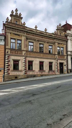 Historická budova s sgrafitovou fasádou a ornamentálním štítem ve Vsetíně