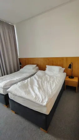 Hotelový pokoj s dvojlůžkem a nočními lampičkami