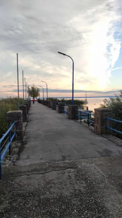 Dlouhé molo s lampami vedoucí k Balatonu za dramatického soumraku