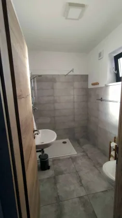 Moderní koupelna se sprchovým koutem a keramickým umyvadlem