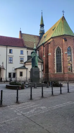Bronzový pomník kazatele Petra Skargy na náměstíčku před gotickým kostelem svatého Ondřeje v Krakově
